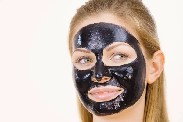 Girl black carbo peel off mask on face — Stock Photo, Image