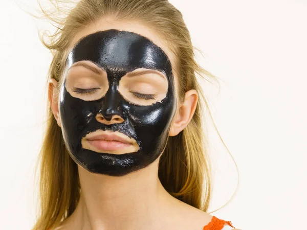 Girl black carbo peel off mask on face — Stock Photo, Image