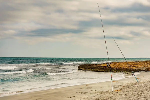 Two fishing poles at the shore of sea. — 스톡 사진