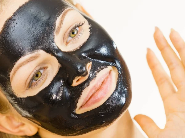 Girl black carbo peel off mask on face — Stock Photo, Image