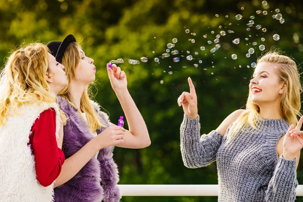 妇女吹肥皂泡，玩得开心 — 图库照片