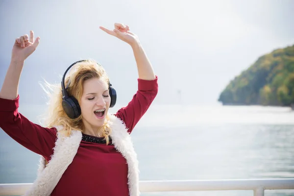 野外ながら音楽を聴いてくれる幸せな女性 歩くのが楽しいヘッドフォンを身に着けている10代の女性 — ストック写真