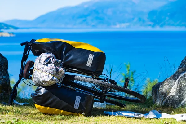 Mountain bicycle with attached bag saddlebag against nature, mountains fjord landscape in Norway