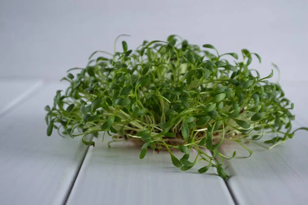 Portion of fresh Garden Cress  on wooden background