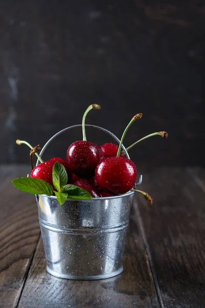 Cherrys in a decorative bucket — Stock Photo, Image
