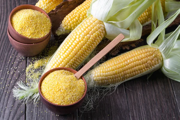 Polenta olgun mısır mısır koçanı ve yeşil yaprakları ile beyaz tabloda seramik bir kabın içinde Mısır irmik
