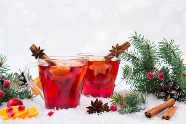 Noel mulled şarap ve malzemeler. Arka plan üzerinde beyaz kar ile boşaltmak