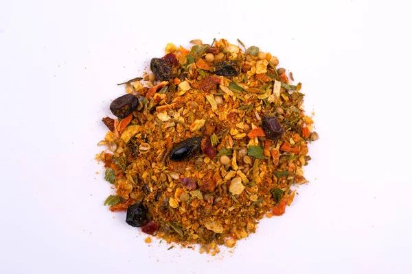 A pile of a spice mix for pilaf. Isolated on white background. Spices consist onion garlic paprika coriander barberry carrot mustard turmeric savory tomatoes cumin cumin black pepper