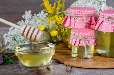 Tatlım bir cam kavanoz ve bal ayı'yı üzerinde rustik ahşap arka plan üzerinde