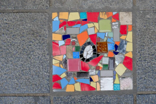 Detail of a multicolored glass mosaic on the floor, mosaic background, texture.