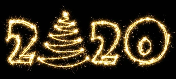 New Year 2020 with Christmas tree made by sparkler . Number 2020 and sign written sparkling sparklers . Isolated on a black background . Overlay template for holiday greeting card