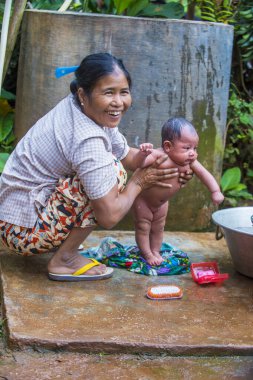 Inle Gölü, Myanmar - 07 Eylül 2017 'de Inle Gölü yakınlarındaki bir köyde çocuklu bir anne 