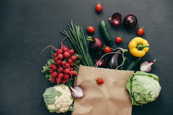 seasonal vegetables radish cabbage onions peppers cucumbers tomatoes dark background