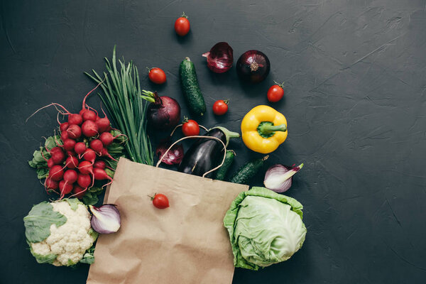 seasonal vegetables radish cabbage onions peppers cucumbers tomatoes dark background