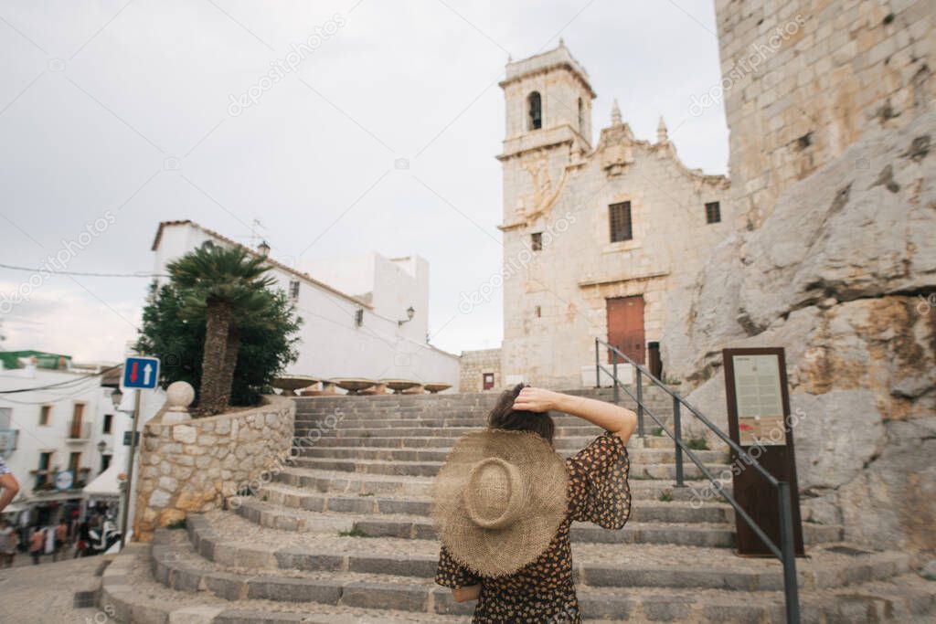 young tourist woman in the streets of the old town of Peniscola, Spain