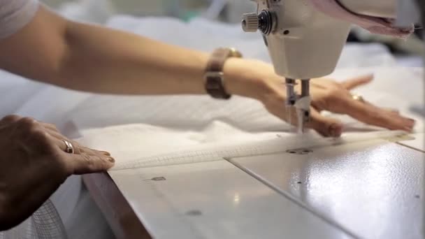 Της γυναίκας στα χέρια όπως αυτή λειτουργεί ένα βιομηχανικών ραπτομηχανών — Αρχείο Βίντεο