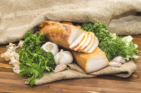 Smoked lard  sliced in small pieces on wooden table — Stock Photo, Image