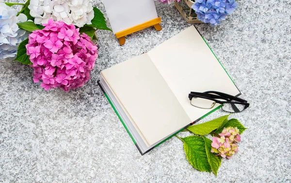 Top view of an open notepad and hydrangea flowers — Stock Photo, Image