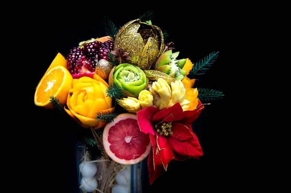 composition bouquet of fruits in a vase on a black background.