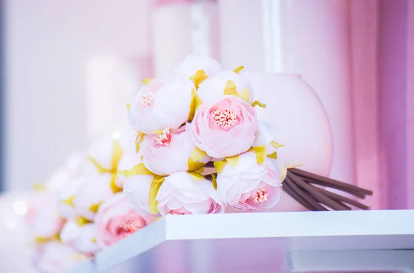 Bouquet gently pink flowers on a blurred background.