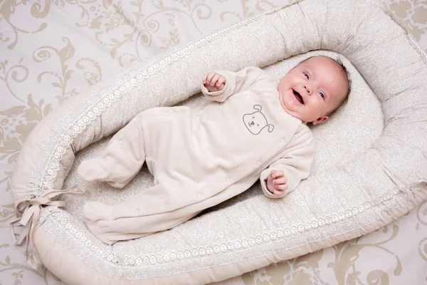 Newborn Little Girl Lies Pastel Cocoon Laughs Royalty Free Stock Images