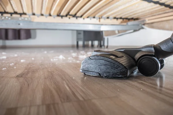 Hoovering the sust on the wood floor — Stock Photo, Image