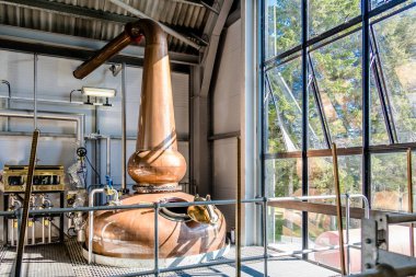 Glenbeg, Ardnamurchan Scotland - May 26 2017 : Ardnamurchan distillery is producing whisky since 2014 and actually expanding their warehouses clipart