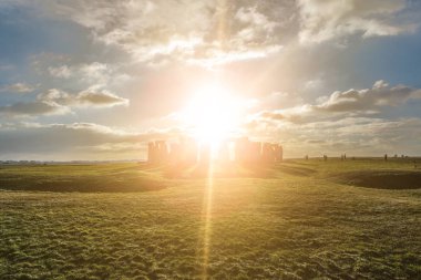 Stonehenge against the sun, Wiltshire, England clipart