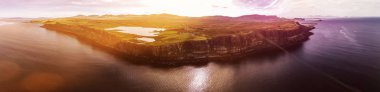 Cinematic aerial shot of the dramatic coastline at the cliffs close to the famous Kilt Rock waterfall ,Skye clipart