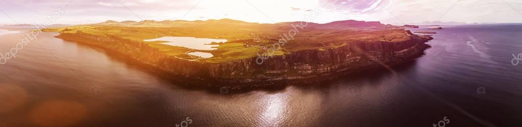 Cinematic aerial shot of the dramatic coastline at the cliffs close to the famous Kilt Rock waterfall ,Skye
