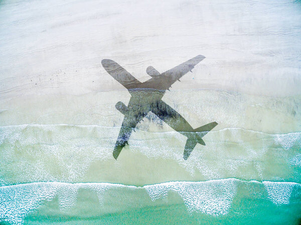 Aerial View of lonely beach with shadow of airplane