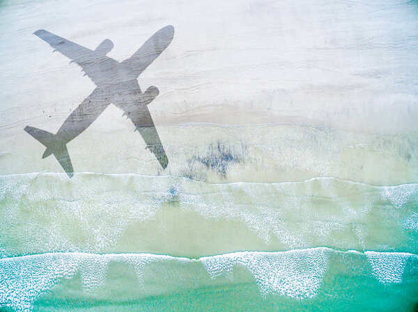Aerial View of lonely beach with shadow of airplane