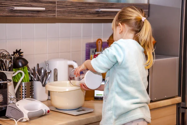 스마트폰 제조 법에 따라 주방에서 와플을 굽는 어린 소녀 — 스톡 사진
