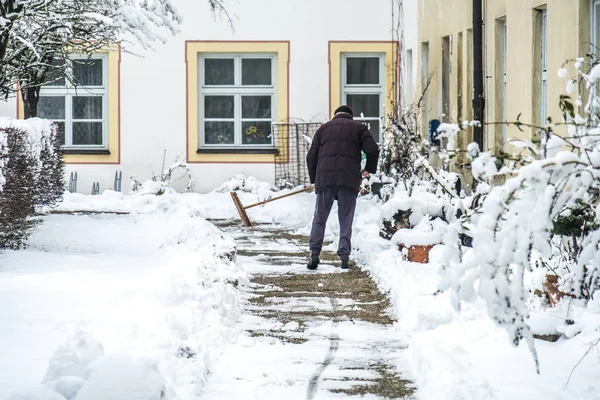 Człowiek, zamiatanie odśnieżanie chodnika — Zdjęcie stockowe