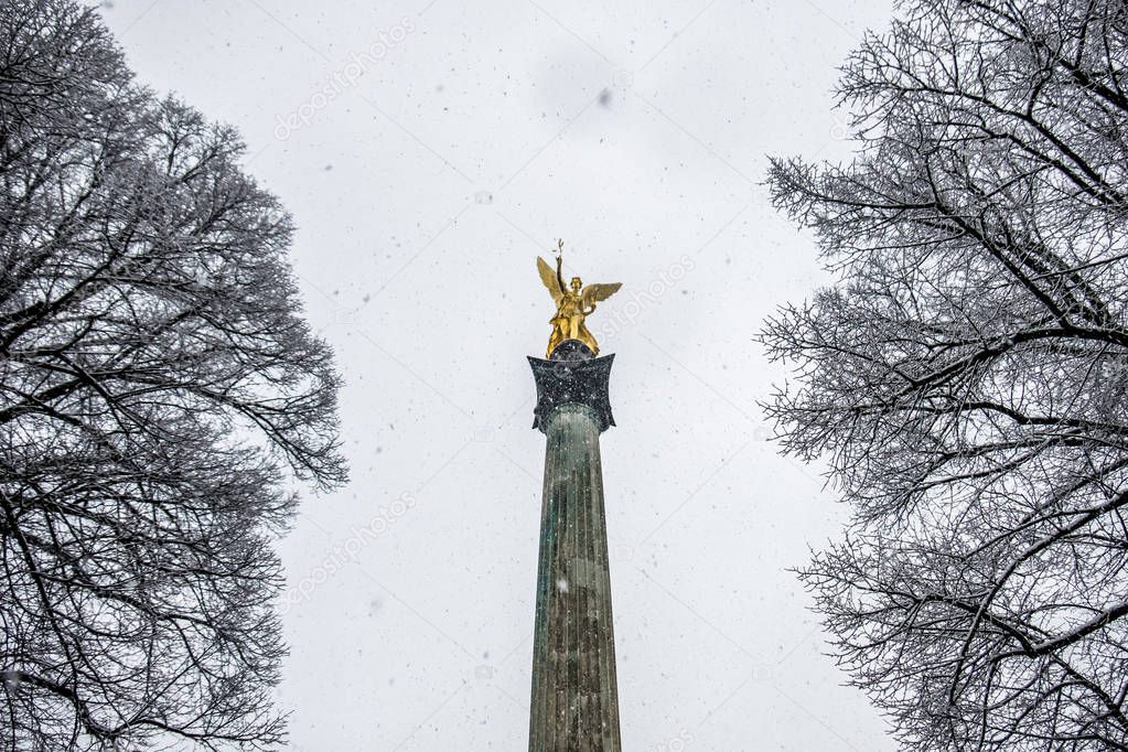 The Angel of Peace on the top of Friedensengel monument in Munich, Germany during the snow srorm