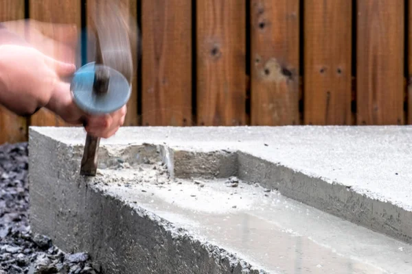 Motion blurred chipping away at the concrete base — Stock Photo, Image