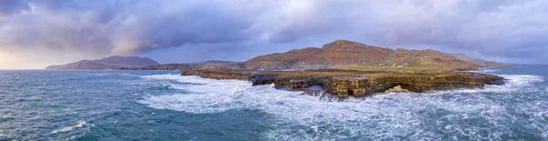 Aerial view of huge waves breaking at Muckross Head - A small peninsula west of Killybegs, County Donegal, Ireland. The cliff rocks are famous for climbing