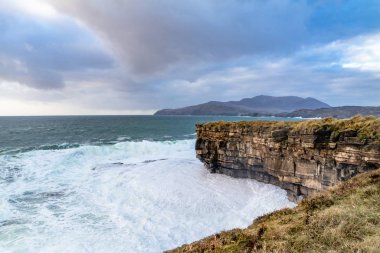 Huge waves breaking at Muckross Head - A small peninsula west of Killybegs, County Donegal, Ireland. The cliff rocks are famous for climbing