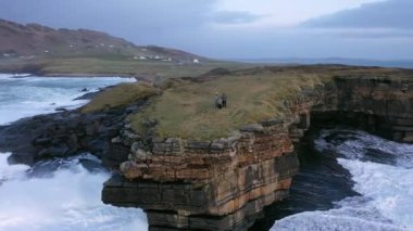Huge waves breaking at Muckross Head - A small peninsula west of Killybegs, County Donegal, Ireland. The cliff rocks are famous for climbing