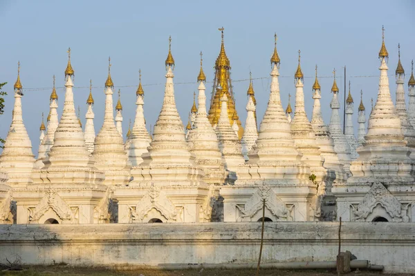 Kuthodaw Pagoda contains the worlds biggest book. There are 729 white stupas with caves with a marble slab inside - page with buddhist inscription. Mandalay, Myanmar