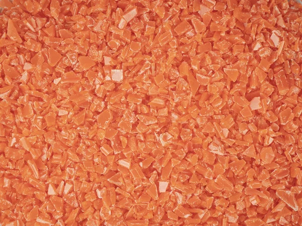 Orange scrap pieces of plastic production background