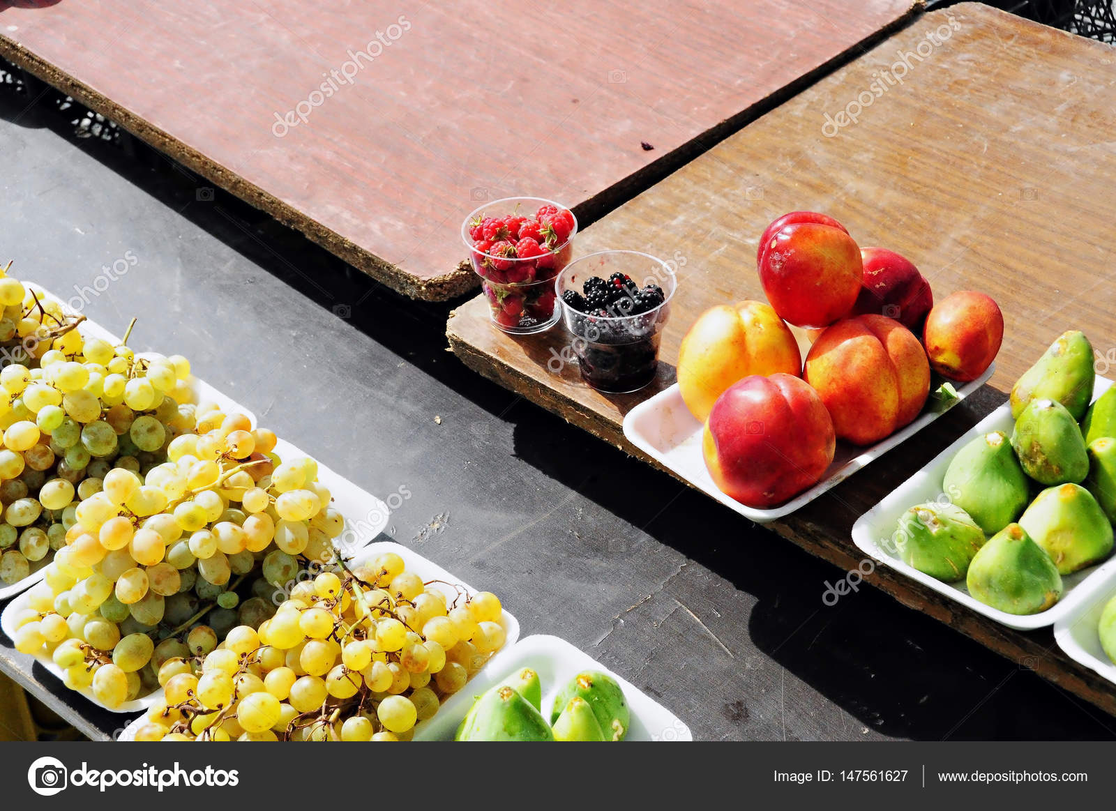 Assorted packaged fruit on wooden table. — Stock Photo © CaitlinWillow