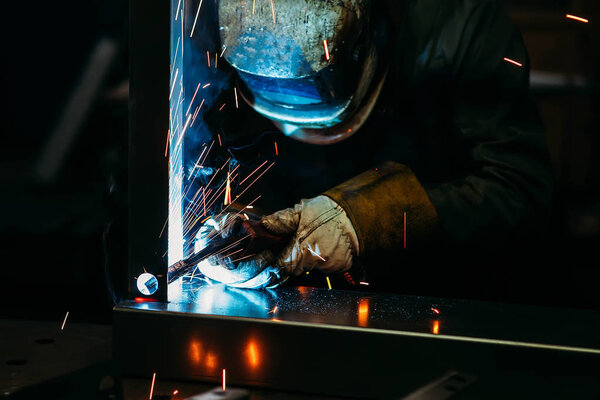 sparks while welder uses torch to welding