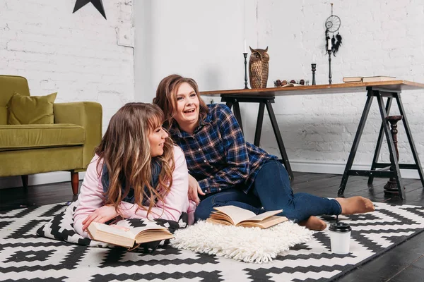 Two students doing homework together and helping each other sitting in a table at home with a homey background — Stock Photo, Image