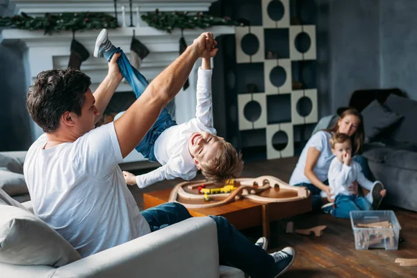 Cute parents play with their sons on the floor together indoor — Stock Photo, Image