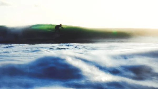 surfer catching breaking wave in Bali