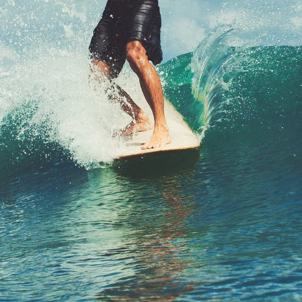 male surfer legs on surfboard