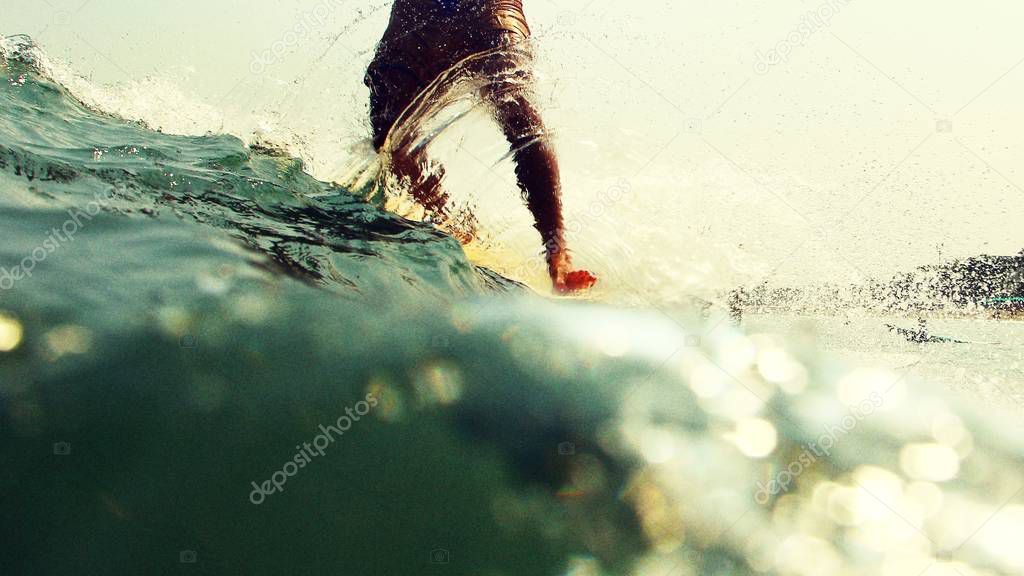 male surfer legs on surfboard