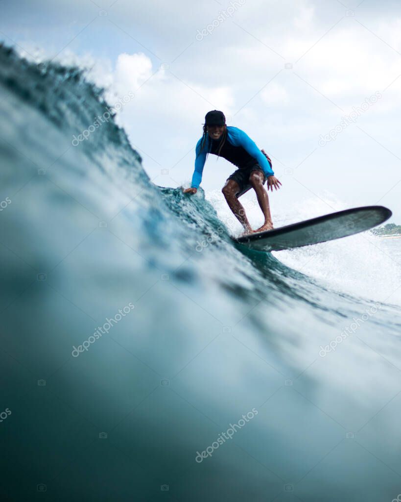 surfer rides a wave on beautiful bali