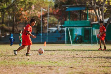 Bali, Endonezya - 27 Ağustos 2019: Endonezya 'nın Bali adasındaki büyük bir futbol sahasında çocuklar antrenman yapıyor